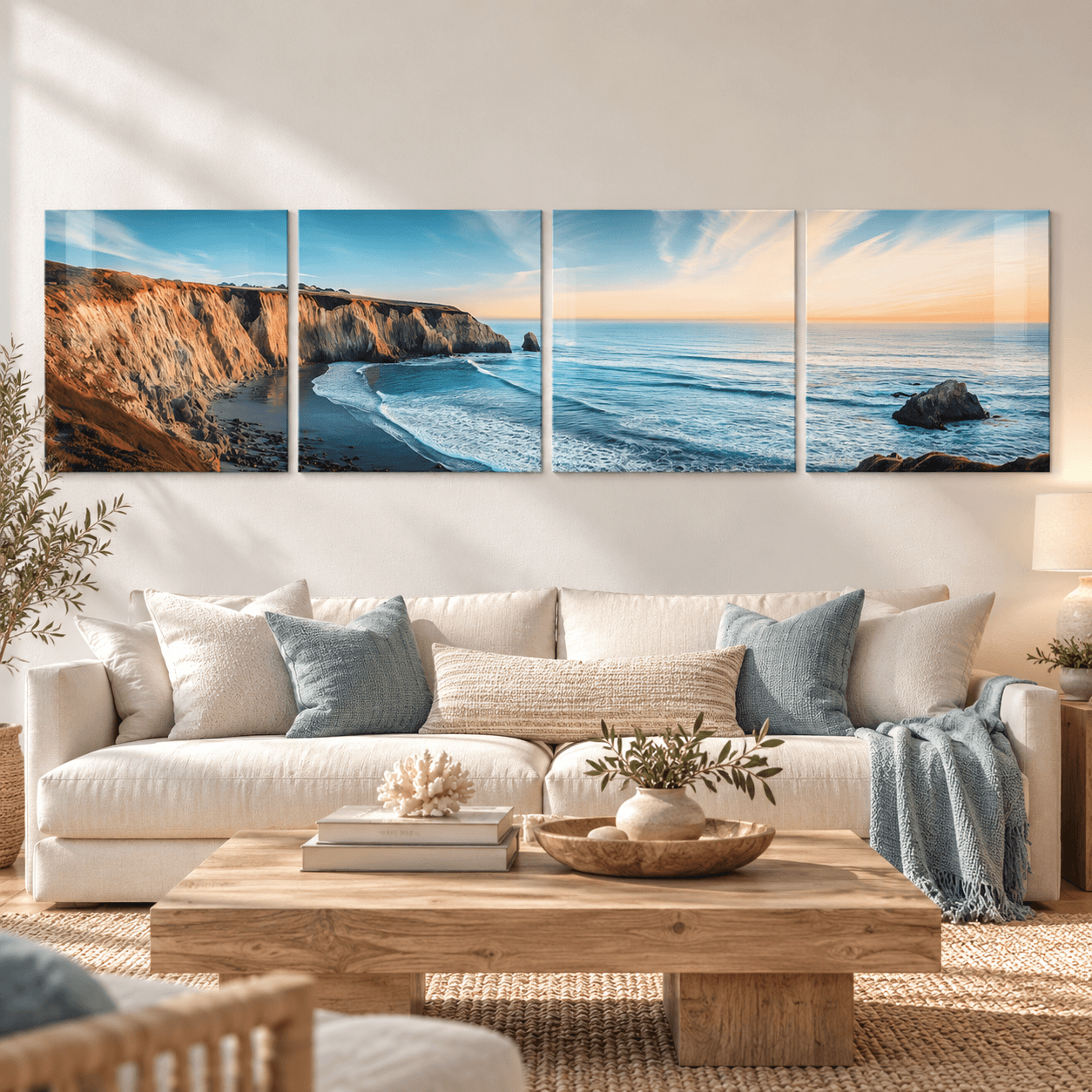 Coastal cliffs and sunset ocean glass wall art panels above a cream sofa in a living room